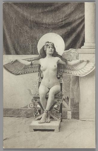 [Seated woman, Egyptian motif setting, arms outstretched]
