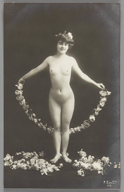 [Standing woman with flower garland]