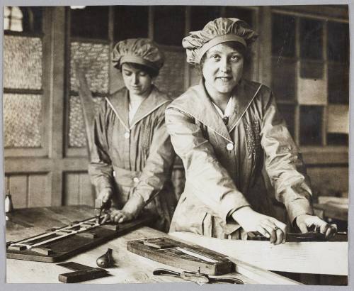 Aeroplane framing and building is now being taught by the L.C.C. at Ferndale-road School, Brixton. Women are being trained as aeroplane assemblers and it is found that the work is quite within their capabilities. The training is free and lasts three or four weeks. Twenty-five shillings a week is paid during the course to each pupil willing to accept a post away from home. Others receive 18s. per week. Railway fare is paid for pupils coming from the country. Women at work on one of the struts