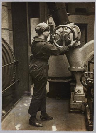 Women making London's gas. The engineers of South Metropolitan Gas Company have trained a staff of women in the work & it is now being entirely run by them. A responsible position-opening the valve