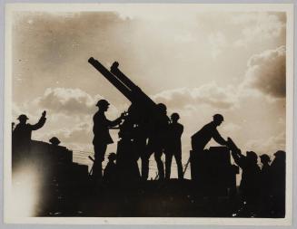 [Gunners loading a gun]