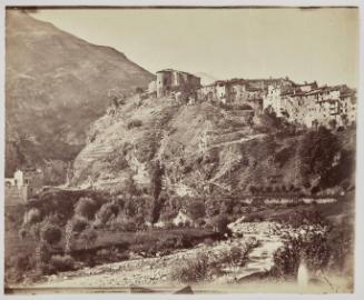 View across a river to an unidentified hilltop town.
