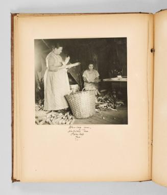Husking corn, Habitant home, Pierreville, Que. Page 36 of The Abenaki; from collection of Canadian albums compiled by Edith S. Watson, 1890s-1930s