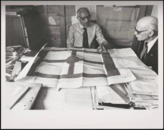  Engineer Tito de Micheli reviewing drawings and plans