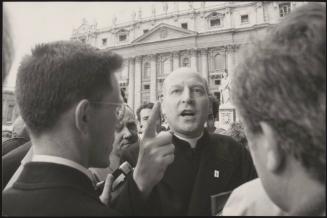 A contesting priest releases a statement to journalists during a protest in front of St. Peter's Church, Rome
