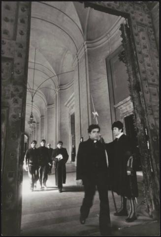 Young men studying to be a part of the church walking through doors at the Vatican City 