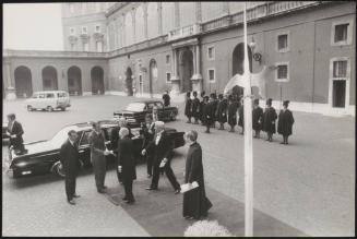 A car is greeted at an event in front of the Apostolic Palace in Rome