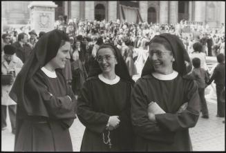 Three nuns in the crowd outside the Apostolic Palace in Vatican City, Rome