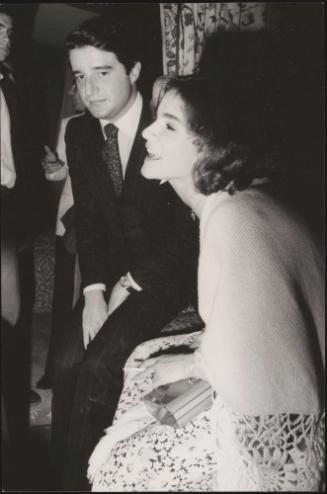 Partners and peers, Christian De Sica and Silvia Verdone at a party
