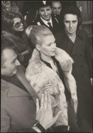 Singer Patty Pravo is escorted through crowds