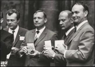 The astronauts from Apollo 11, Neil Armstrong, Michael Collins and Buzz Aldrin proudly show the medals they've just been presented 