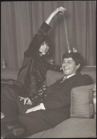 Sir John Paul Getty and his second wife, Talitha Getty playing with a slinky