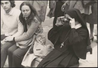 A nun taking a photo in Piazza di Spagna