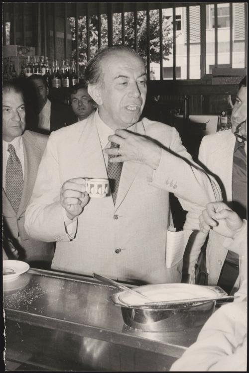 Carlo Donat-Cattin drinking espresso at a bar 