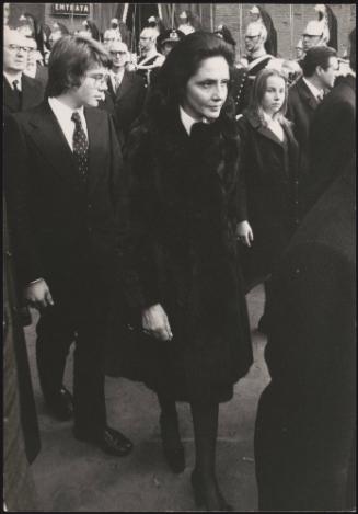 Vittoria Leone dress in black marches through the street at a formal procession