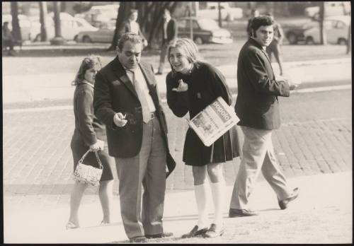 A young woman holding a copy of Il Popolo newspaper, spreading Marxist-Leninist convictions to passers-by in Piazza San Giovanni, Rome