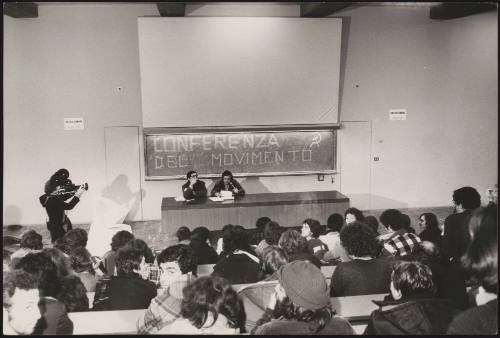 Two speakers are filmed at a conference of the Communist Party Movement in a university