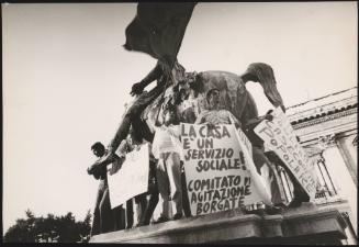 Five demonstrators affiliated with the Italian Communist Party stand on the statue of Marcus Aurelius on the Campidoglio in Rome, protesting against high rent and the right to cheaper housing