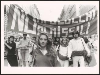 A young woman leading a group at an anti-nuclear march