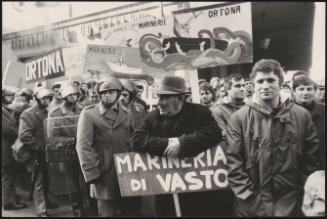 Fishermen protest with placards at the marina