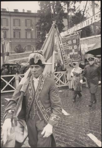 A man in an admirals uniform carries a flag at an Anti Fascist rally