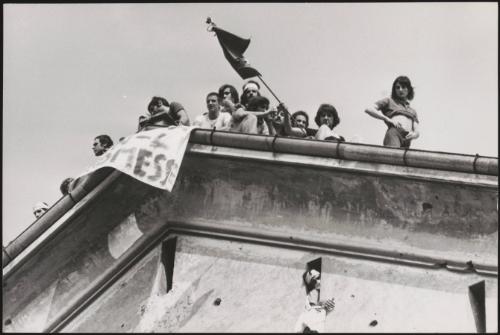 A group of protesters on the roof of a prison  
