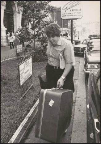 Portrait of a woman carrying suitcases