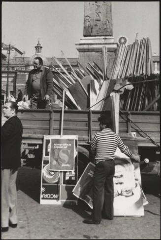 A man on a truck full of DC protest placards in Piazza del Popolo