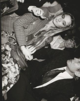 The poet Yevgeny Yevtushenko with guest at a party