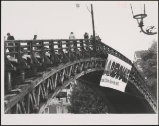 A bridge with a sign 'La Biennale 1974', advertising The Venice Biennale in 1974