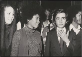 A group of well dressed young men and women