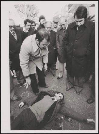 Carlo Moro with Masono, chief of the street patrol police, inspect the body of Martino Zicchitella