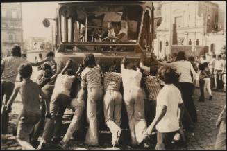 Demonstrators push back a bus in Caserta