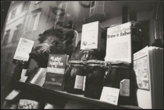 A shop window with books, jars and wild boar's head