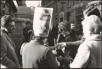 A crowd checking lottery tickets numbers