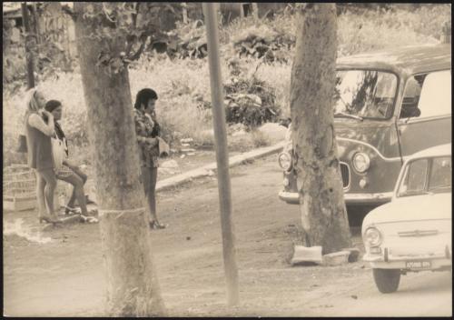 Prostitutes wait on a side road