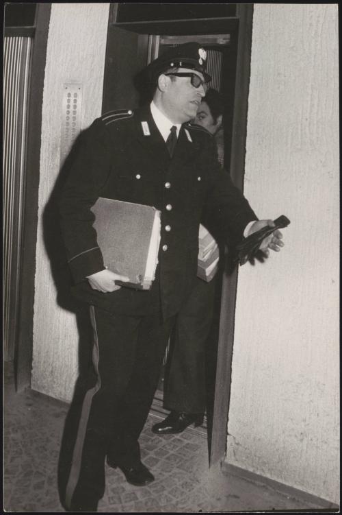 Policemen with phone tapping folders