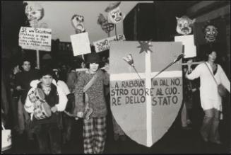 A demonstration against Police brutality; the Indiani Metropolitani carry placards, bongos and grotesque papier maché heads on sticks