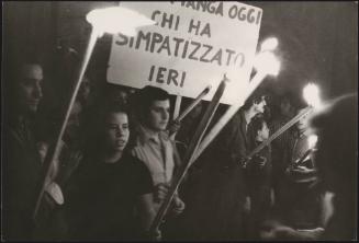 People hold burning torches at a demonstration 