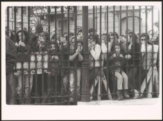 People mourning at The Great Synagogue of Rome's railings after a terrorist attack