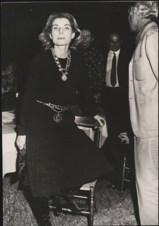 Palma Bucarelli poses by a table at a party