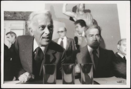 The journalist and publisher Guilio Einaudi sitting at a table with the politician and journalist Pietro Ingrao