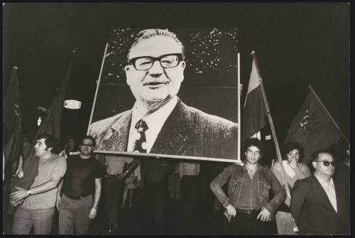 A large portrait of Salvador Allende is marched through the streets at a demonstration in support of democracy in Chile
