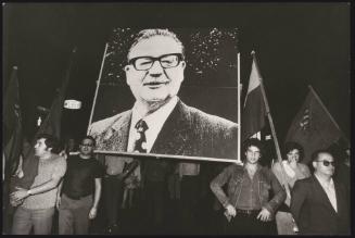A large portrait of Salvador Allende is marched through the streets at a demonstration in support of democracy in Chile