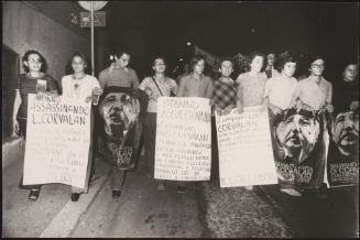 Protesters carrying placards with messages of solidarity with Chile and Luis Corvalan, the general secretary of the Communist Party of Chile