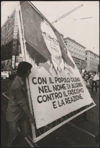 Protesters carry a large hand painted portrait of Salvador Allende