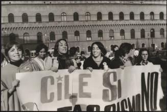 Anti Pinochet protestors hold up their banner