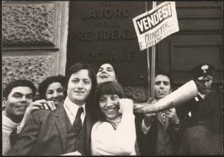 A group of demonstrators stand outside  


