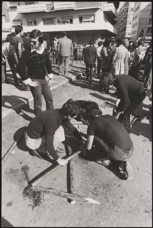 Demonstrators preparing a wooden structure on the ground