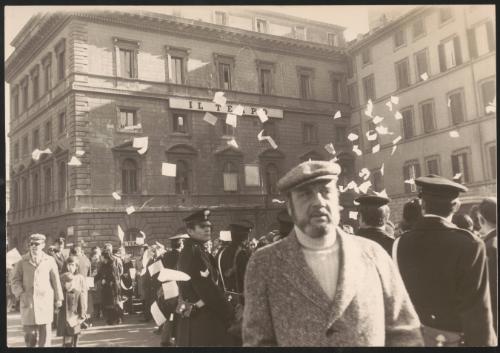 Leafleting outside a building with the sign 'il tempo'